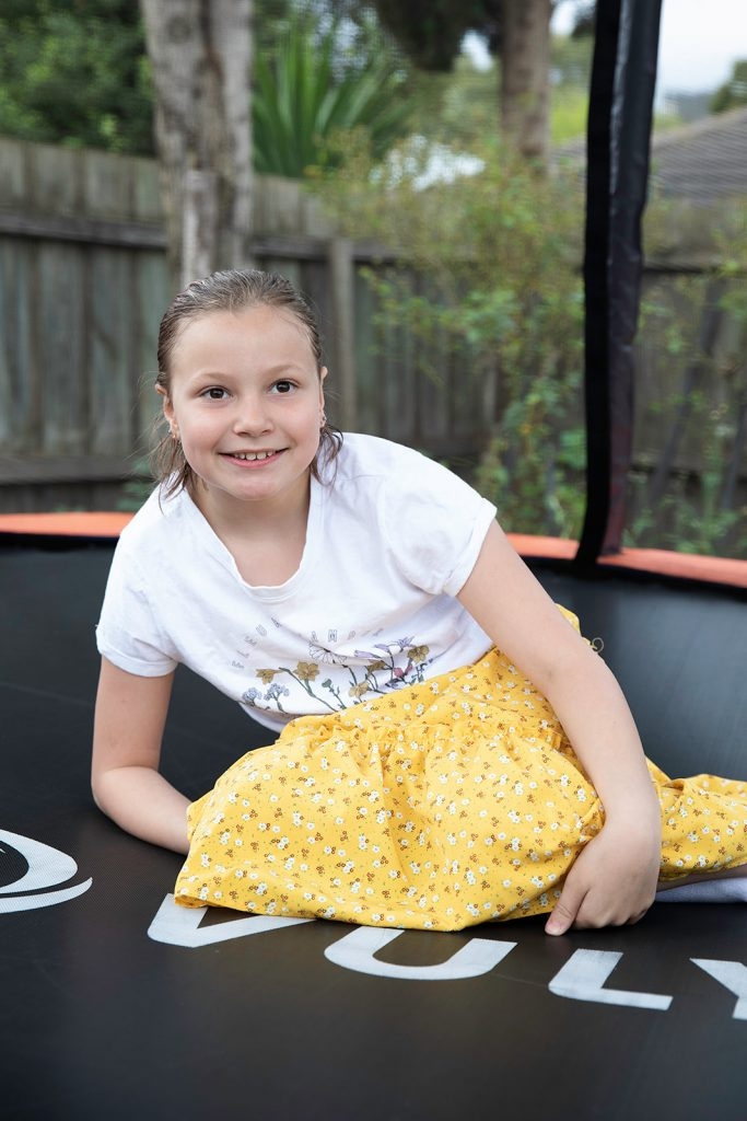 Child sitting on trampoline